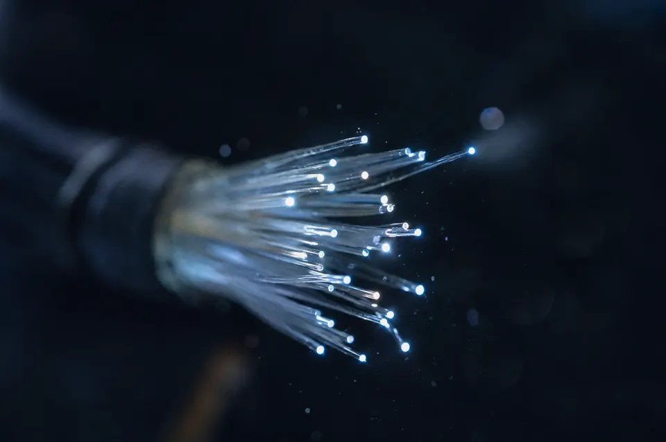 Illustration: Glowing fibre-optic cable ends in the dark