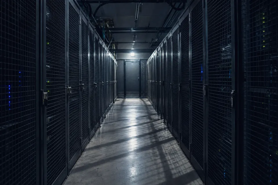 Illustration: A dim corridor of locked mesh server cages
